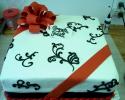 Very unique sheet cake decorated with red ribbon