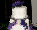 White wedding cake trimmed in purple