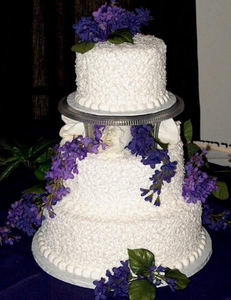 White wedding cake trimmed in purple